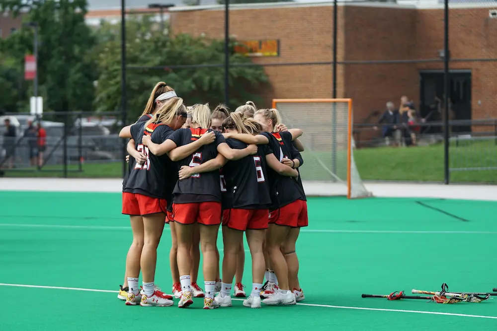 A women's sports team huddled together